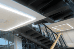 LED surface linear lighting installation in contemporary building ceiling.
