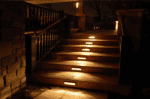 LED step light illuminating outdoor staircase at night for safety and aesthetic appeal.