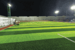 LED flood light illuminating a sports field at night.