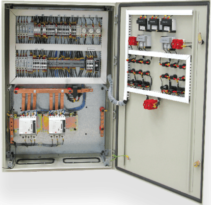 Enclosure wall-mounted panel with electrical components for industrial automation.